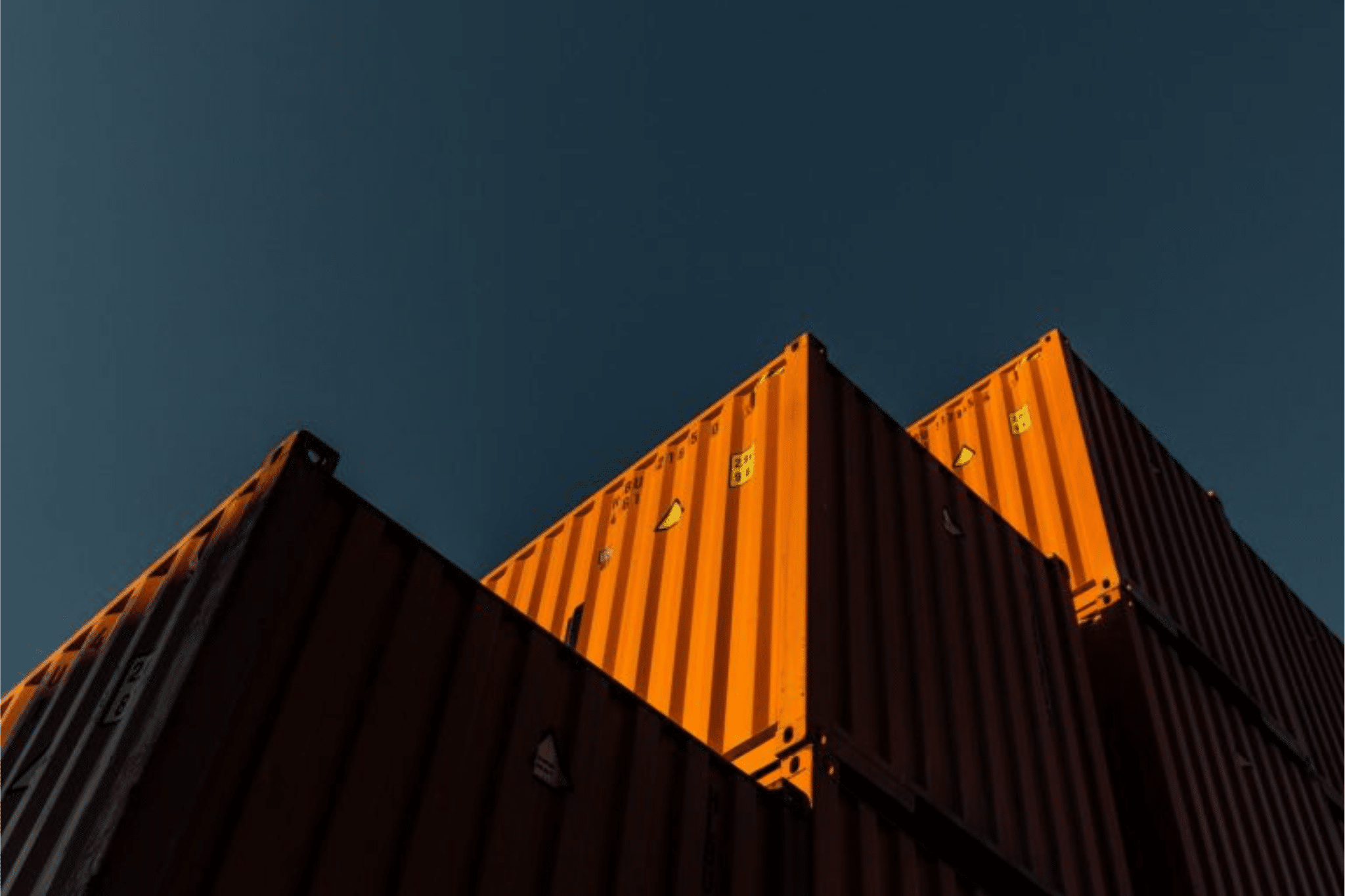 red containers stacked with blue sky